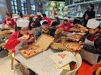 Students try the pizza they made and they    all enjoy the cooking experience in this life-wide learning activity.